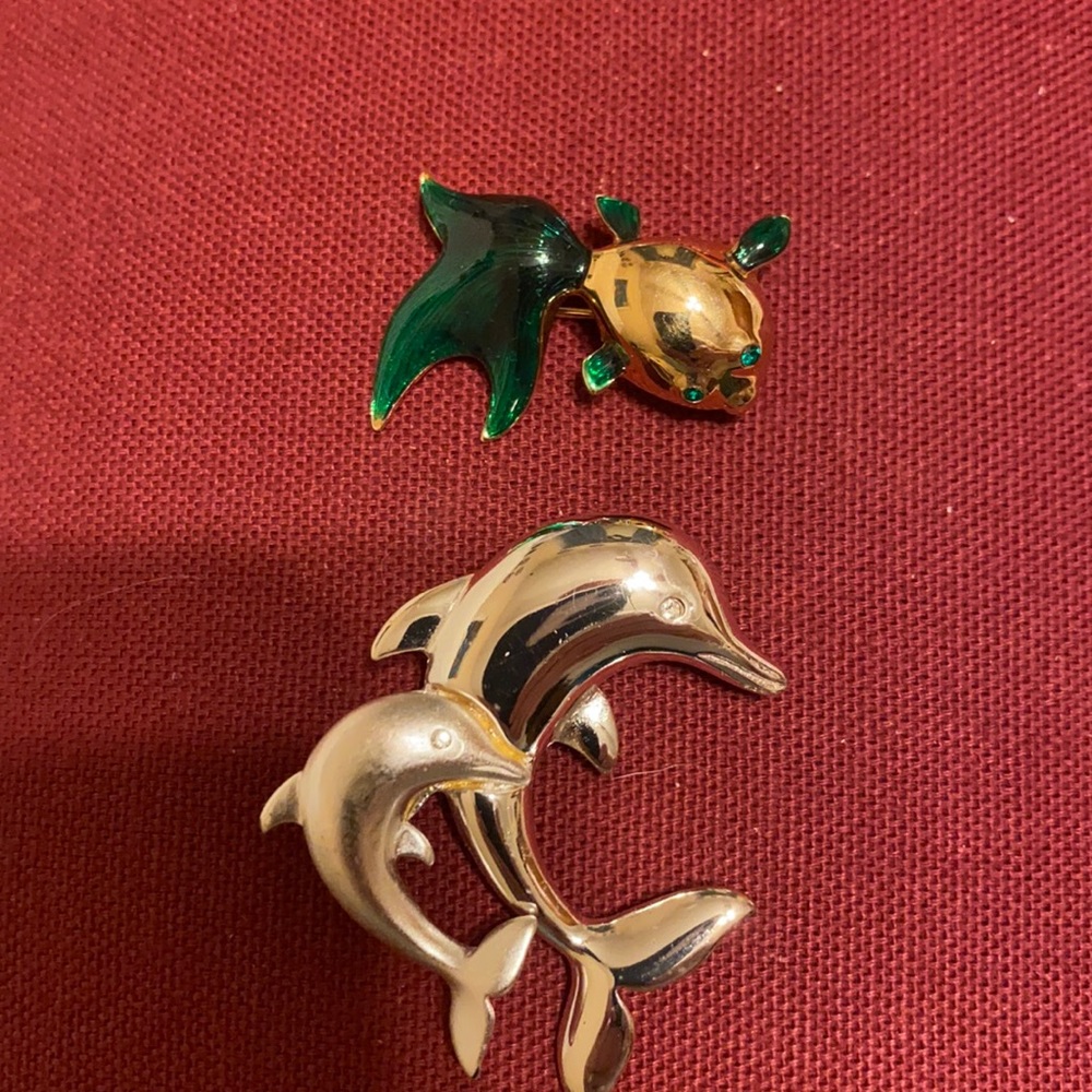 2 pins. One fish and one dolphin